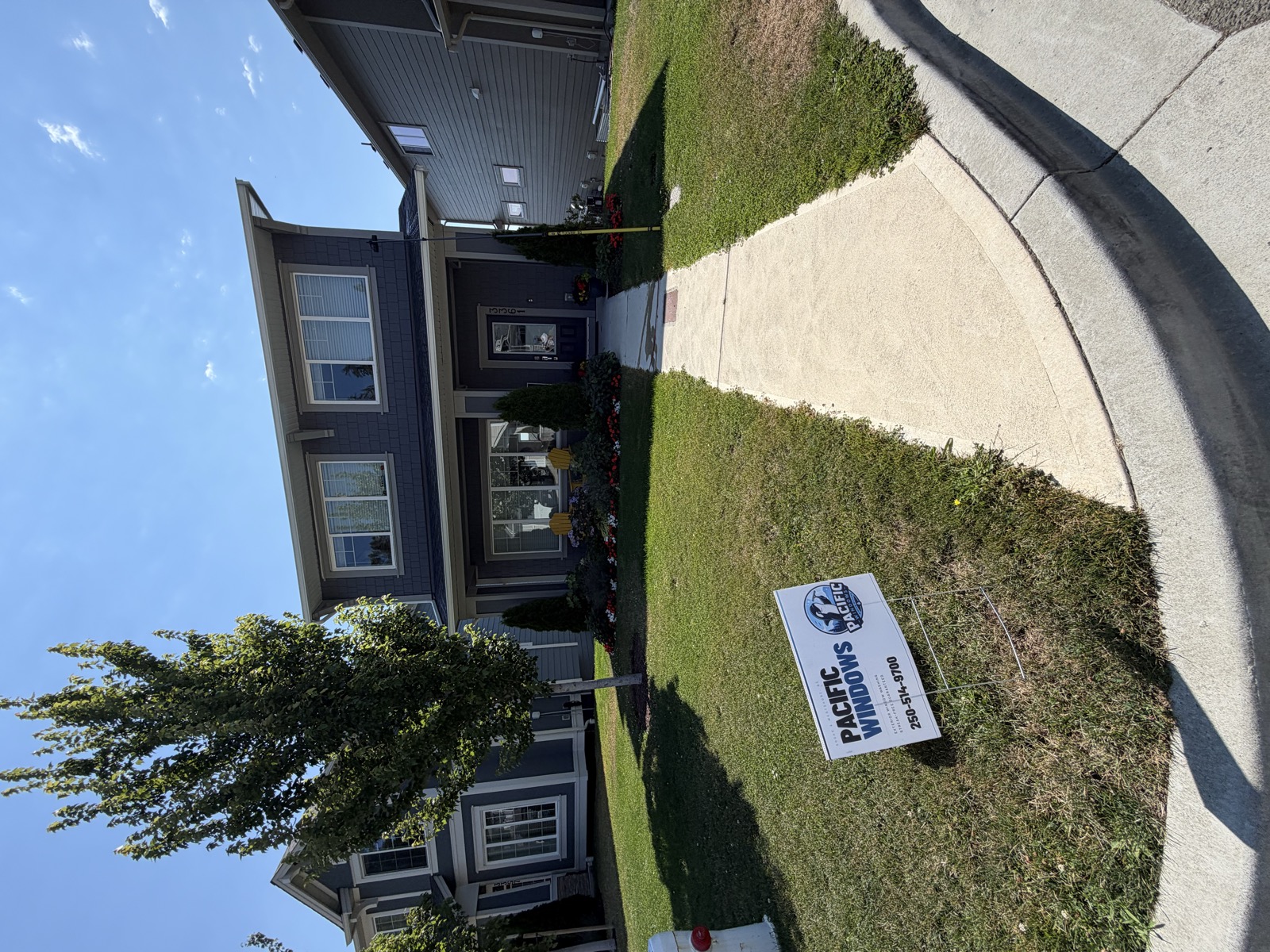 Pacific Windows lawn sign in front of a freshly cleaned home in Sooke